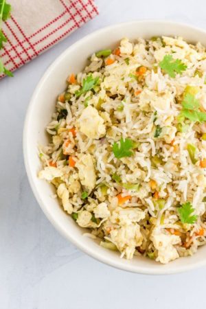 Chinese Style Egg Fried Rice with Vegetables and Cilantro High Angle View / Directly Above Photo. Fried Rice, Comfort Food, Oriental Cuisine Concept.